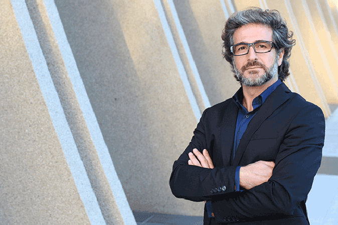 Middle man with arms crossed standing outside